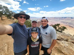 Here's an alt tag for the image: Family selfie at the Grand Canyon.